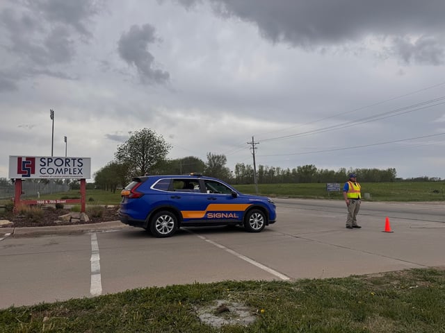 Signal of Lincoln officer and patrol vehicle at the entrance to the Lincoln Sports Foundation Sports Complex
