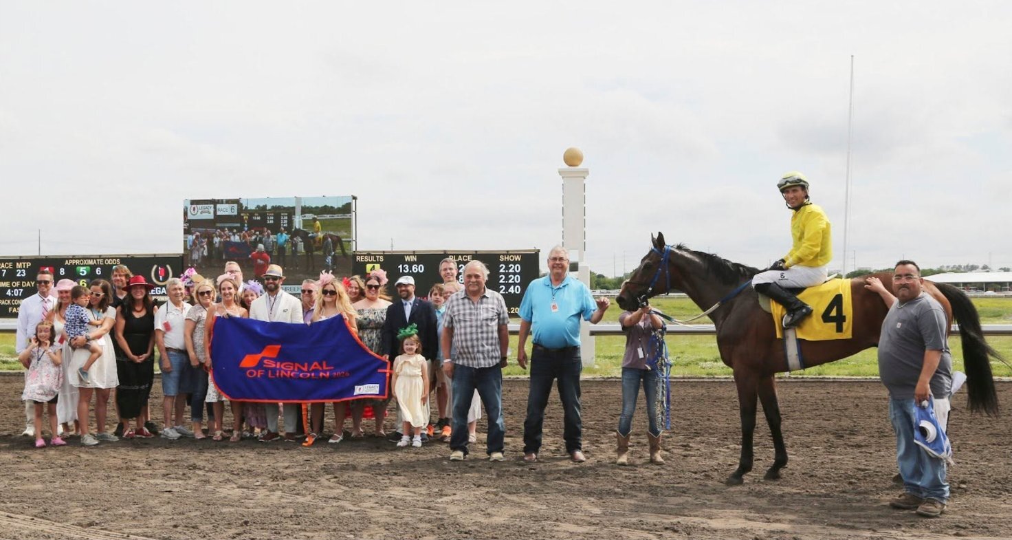 Signal of Lincoln and Team Jack families in the winner's circle at Nebraska Derby Day at Legacy Downs in Lincoln
